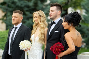 Bride and groom posing with their godparents